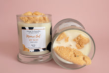 Load image into Gallery viewer, Candle with cookie-shaped wax pieces and visible label on a neutral background