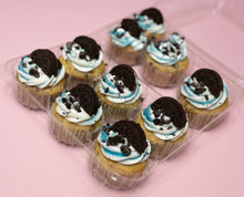 Load image into Gallery viewer, Cupcakes with Oreo cookies on top in a clear container with a pink background