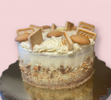 Load image into Gallery viewer, Layered dessert with cookie pieces on a reflective surface
