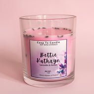 candle scented in lavender and amber with label on pink background